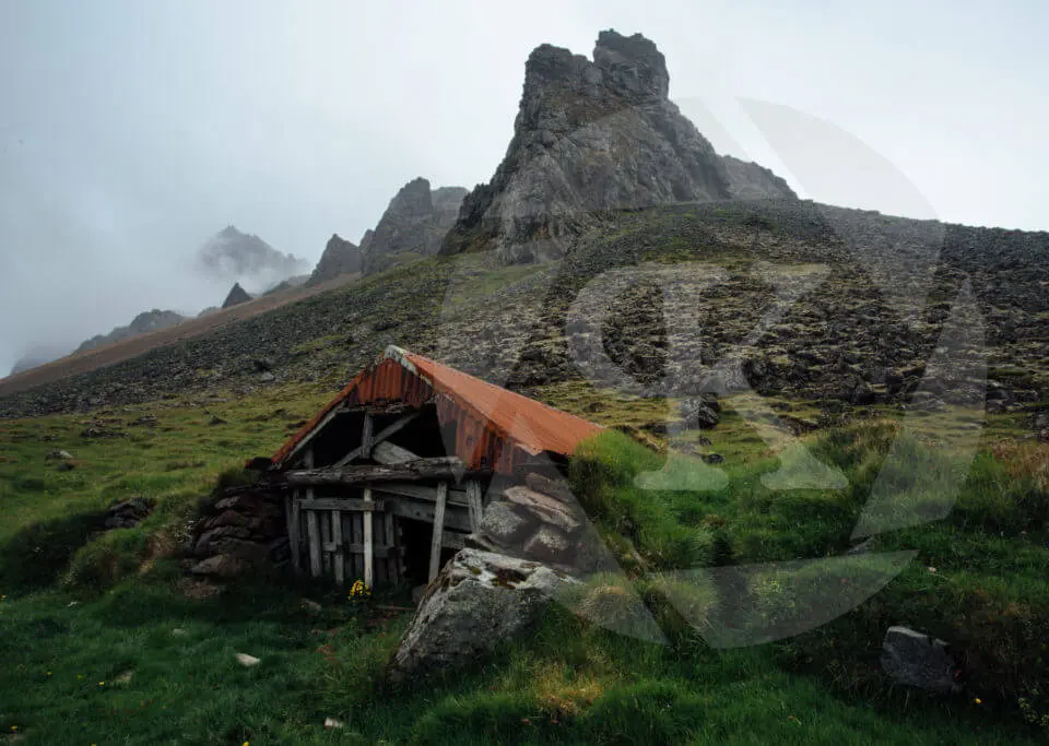 An abandoned house on a rocky landscape