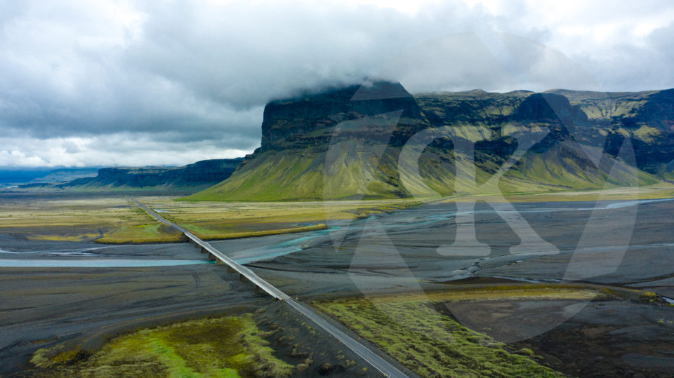 Aerial shot of a highway next to glaciers