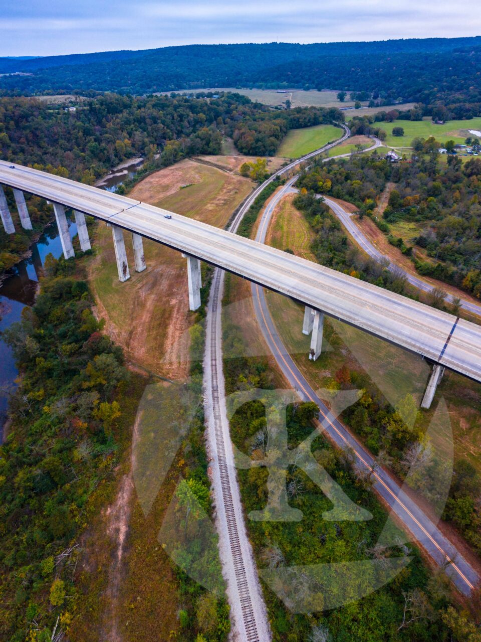 Aerial shot of a highway going over a railroad
